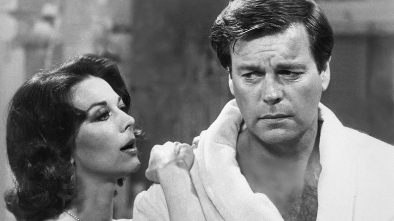 Natalie Wood leaning on Robert Wagner who looks upset