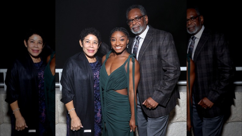 Simone Biles posing in between her parents, Nellie and Ronald Biles