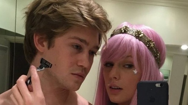 Taylor and Joe take a bathroom selfie