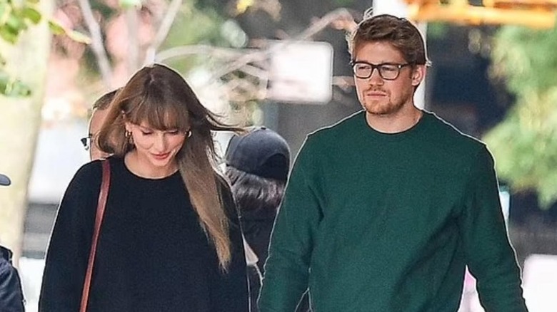 Taylor and Joe walking, holding hands