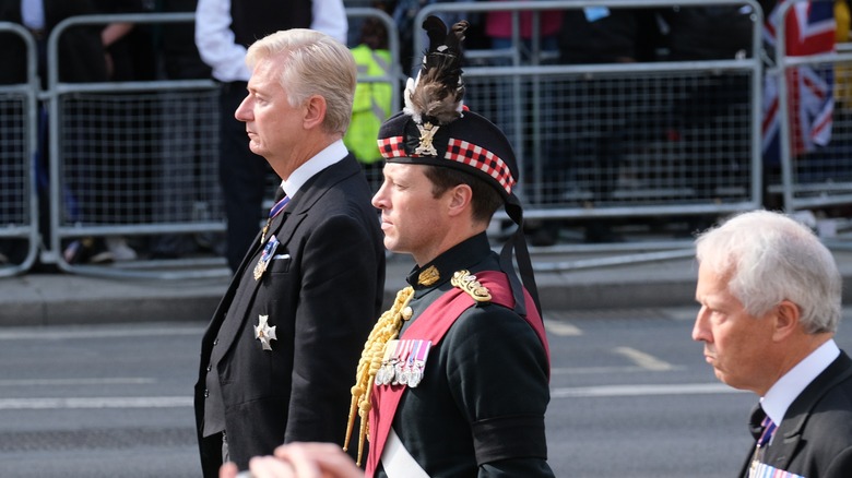 Major Jonathan Thompson following the coffin of the queen 