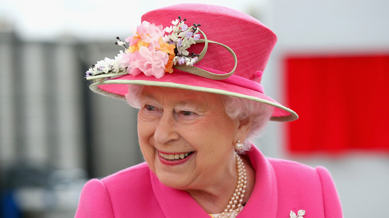 Queen Elizabeth smiles at an event. 