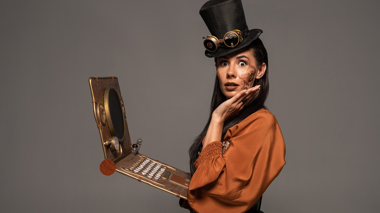 steampunk woman with fascinator and metal laptop