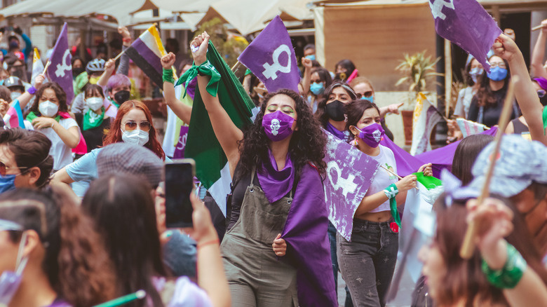 protestors waving feminist flags