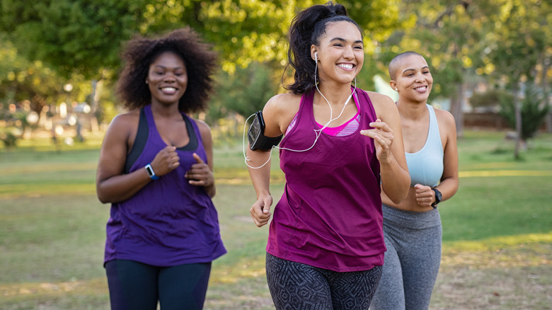 Three women running together