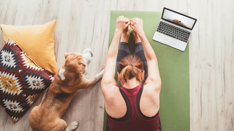 Woman stretching with her dog