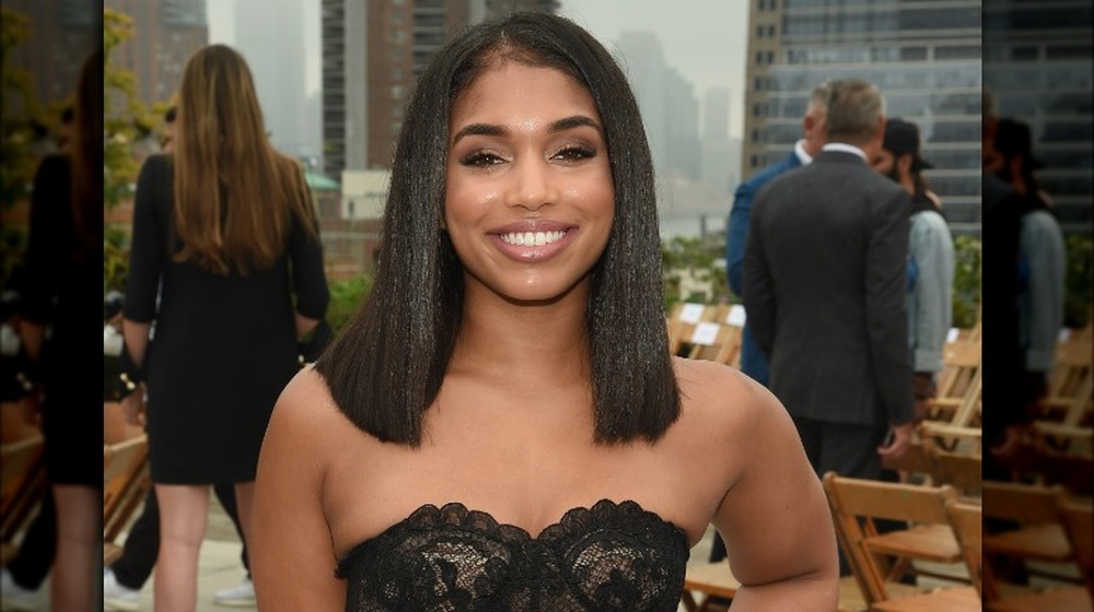 Lori Harvey wearing black lace, smiling