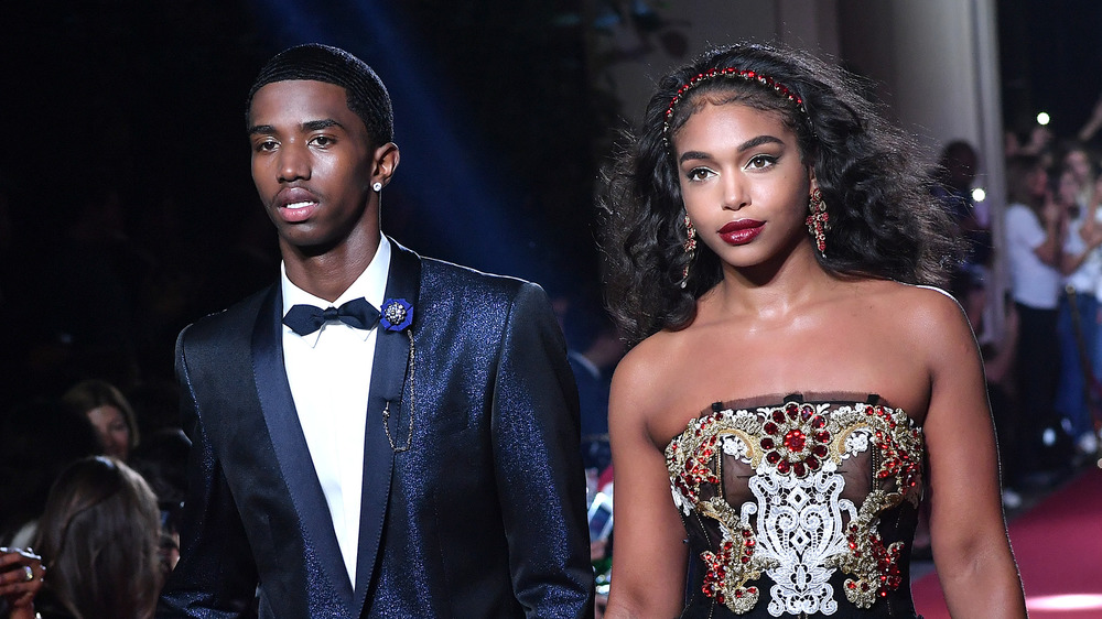 Lori Harvey and a male model on the runway