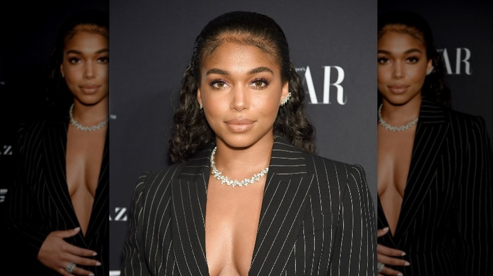 Lori Harvey in a pinstriped suit