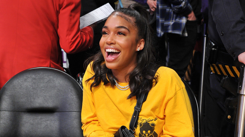 Lori Harvey wearing yellow, grinning