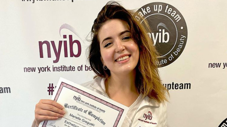 marielle greguski holding certificate