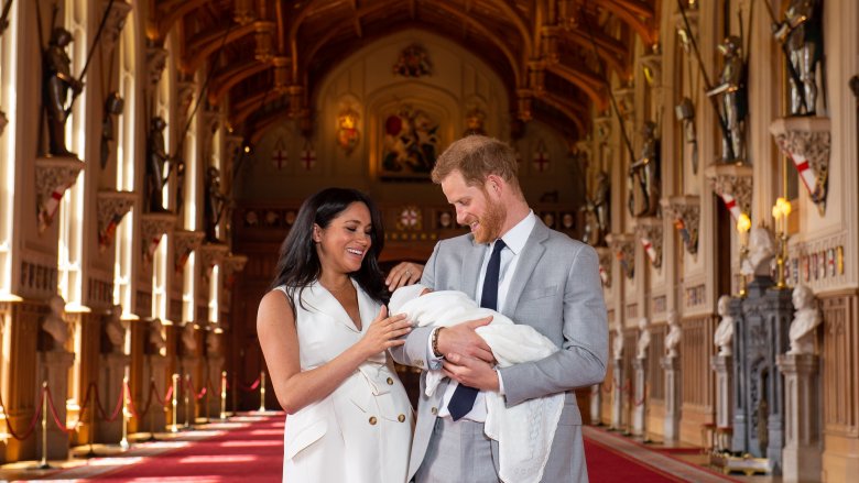 Meghan and Harry holding baby in Windsor Castle