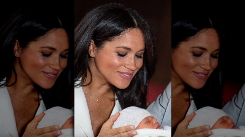 Meghan peering at newborn son