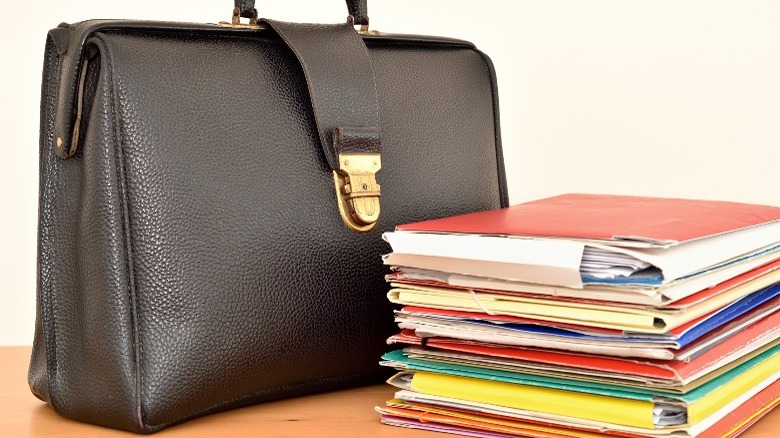 Briefcase with stack of documents