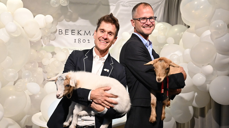 Beekman 1802 founders Dr Brent Ridge and Josh Kilmer-Purcell holding goats at QVC event 