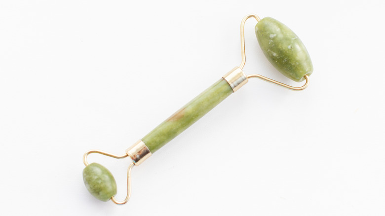 Picture of a jade roller on a white backdrop 