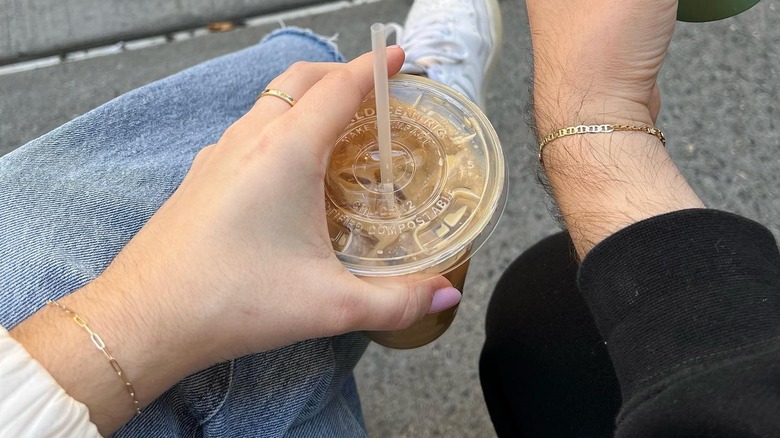 Two people wearing matching permanent bracelets