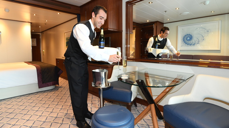 Butler brings drinks to guest room