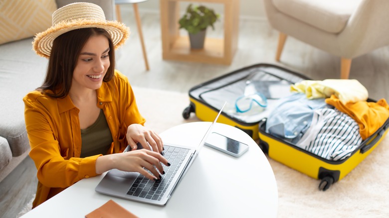 Woman planning trip on laptop