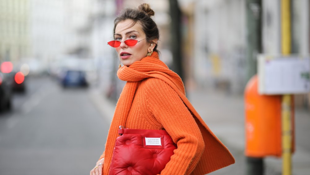 A model wearing an orange ASOS sweater dress