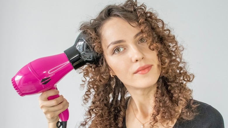 Woman using hair diffuser