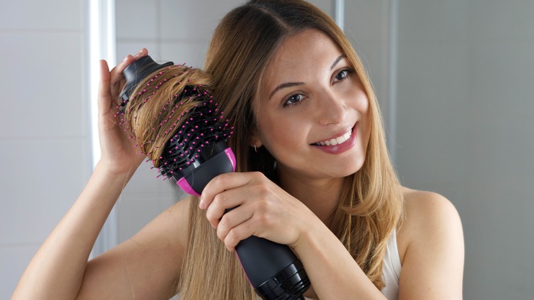 Woman blow drying hair