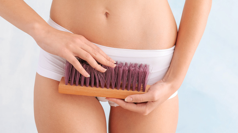 woman holds cleaning brush