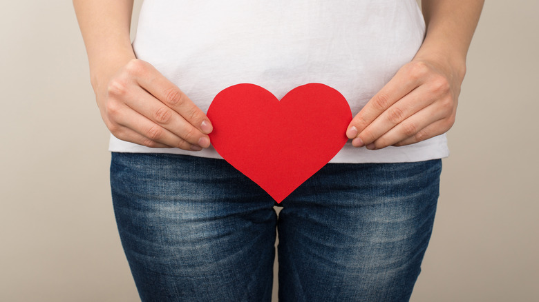 woman holding heart cutout 