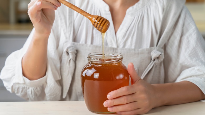 person with a jar of honey