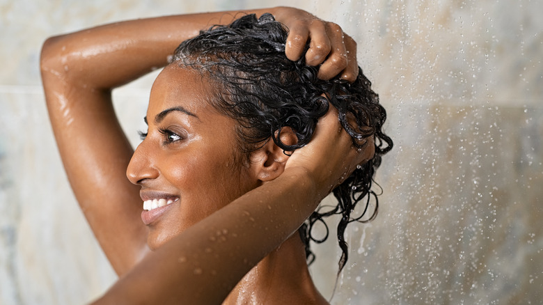 Woman washing hair in shower