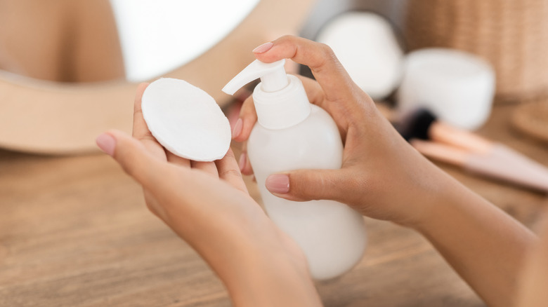 Woman applying product to cotton