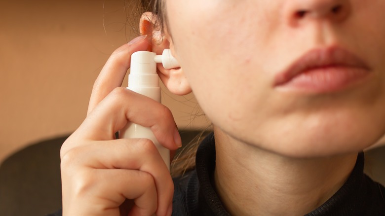 woman cleaning ear