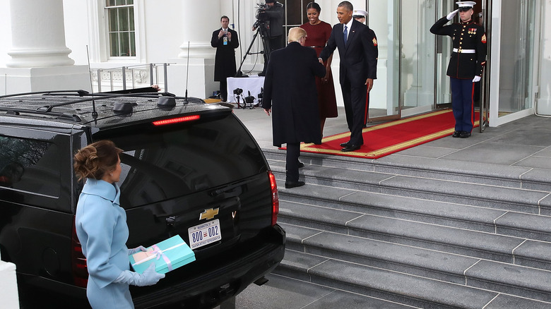 Donald Trump walking ahead of Melania Trump