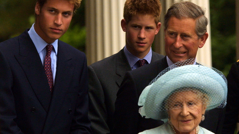 Princes William and Harry, King Charles, and the Queen Mother posing