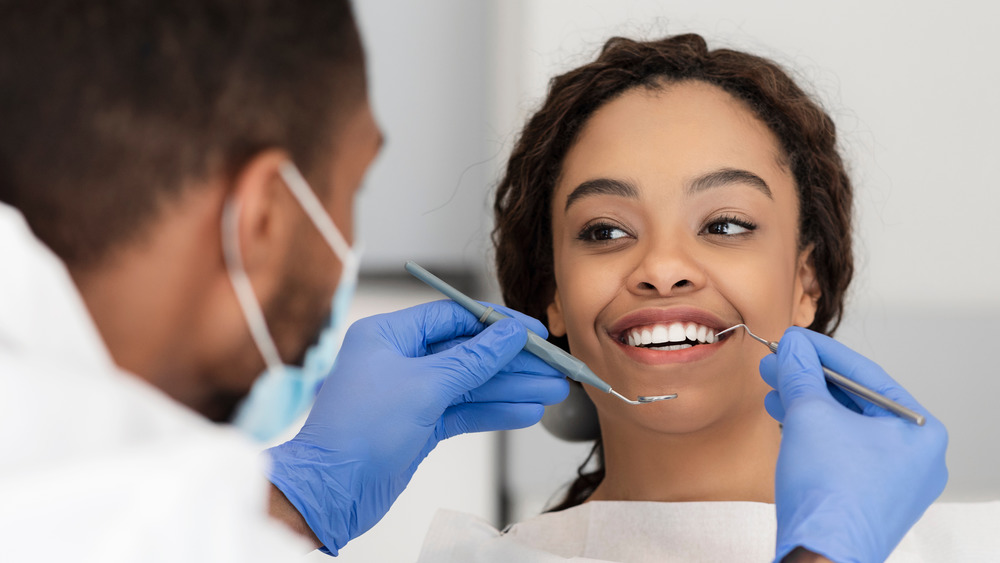 A dentist working on a smiling patient 