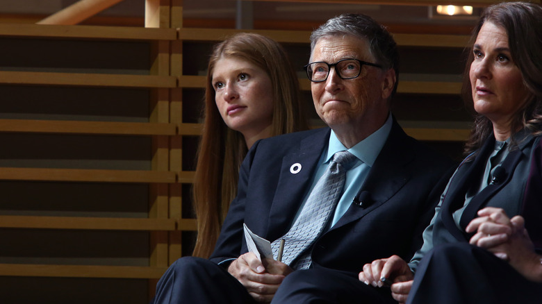 Bill, Melinda, and Jennifer Gates listening to speech