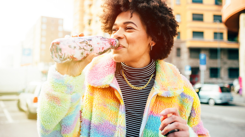 Woman with reusable water bottle