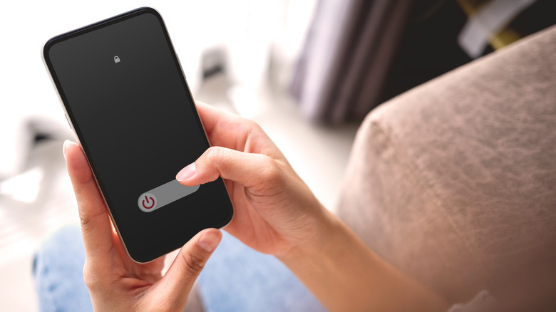 Woman turning off cell phone