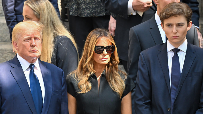 Donald Trump, Melania Trump, and Barron Trump standing together