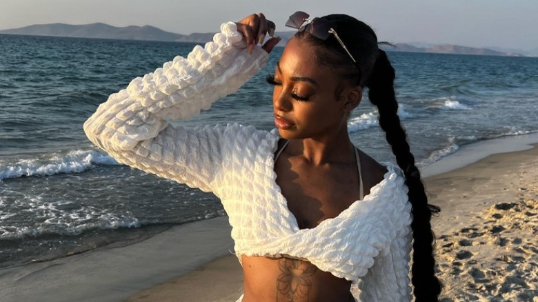 Person at beach in bikini and crop top