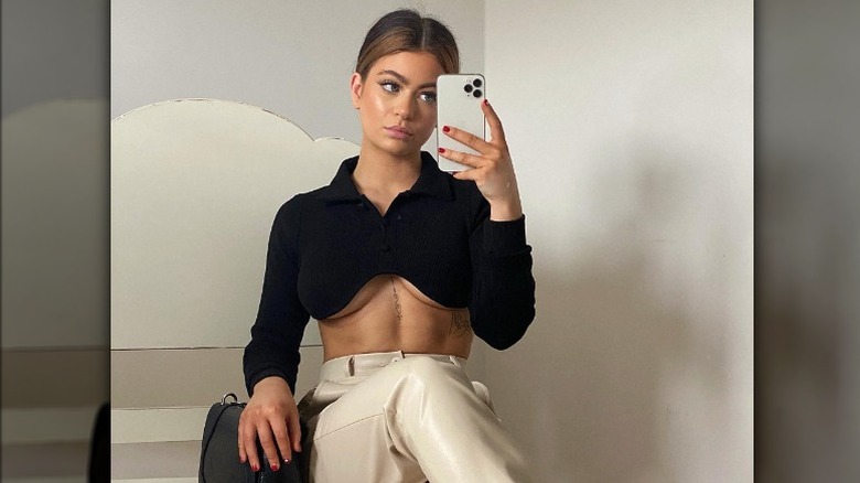 Woman taking selfie in crop top