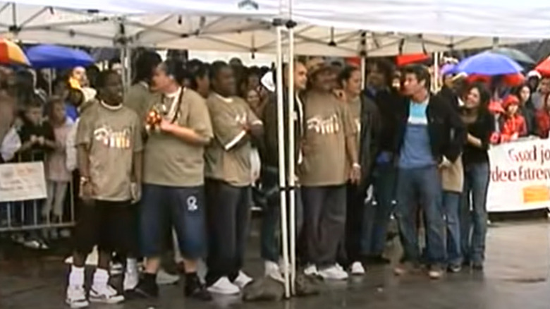 The Higgins and Leomitis family standing under a tent with Ty Pennington