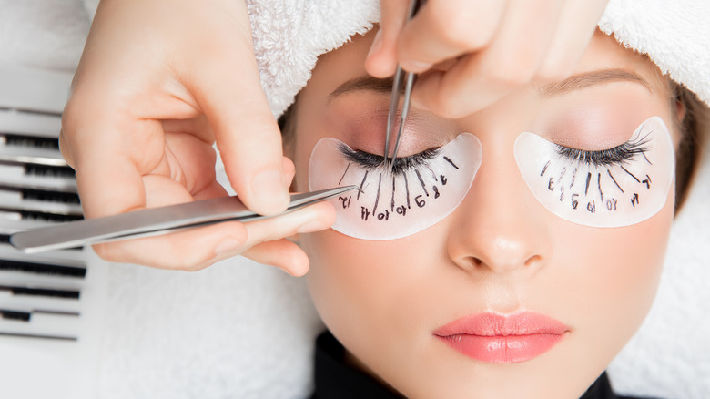 Woman getting eyelash extensions