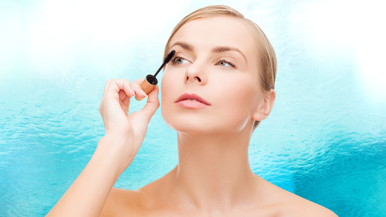 woman applying waterproof mascara