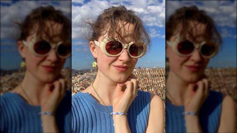 Woman smirking in circular sunglasses