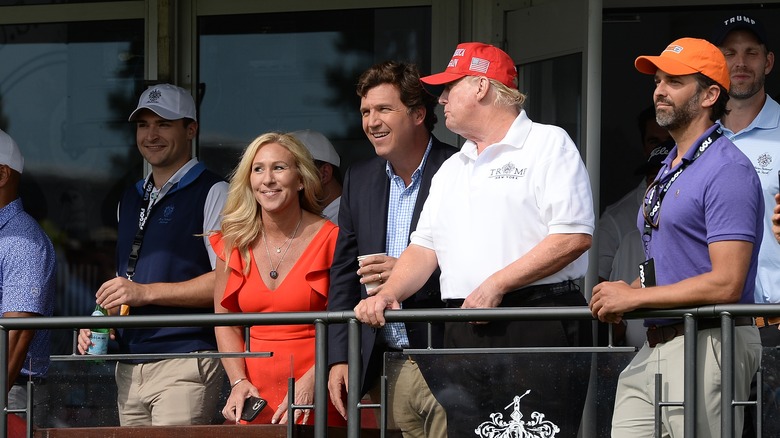 Tucker Carlson and Trump at an event 