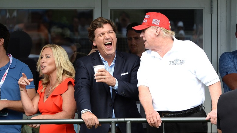 Tucker Carlson and Donald Trump laughing