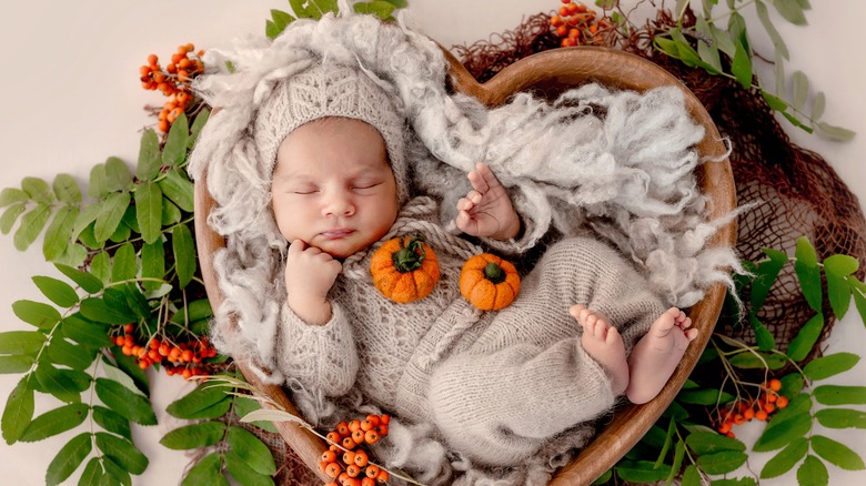 small baby in autumn-themed photoshoot