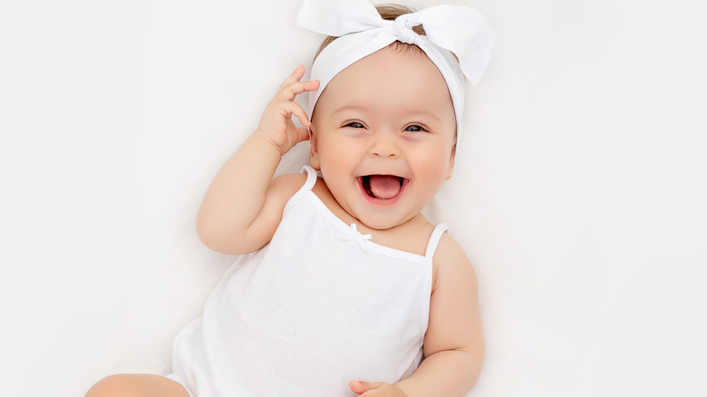 happy newborn wearing headband