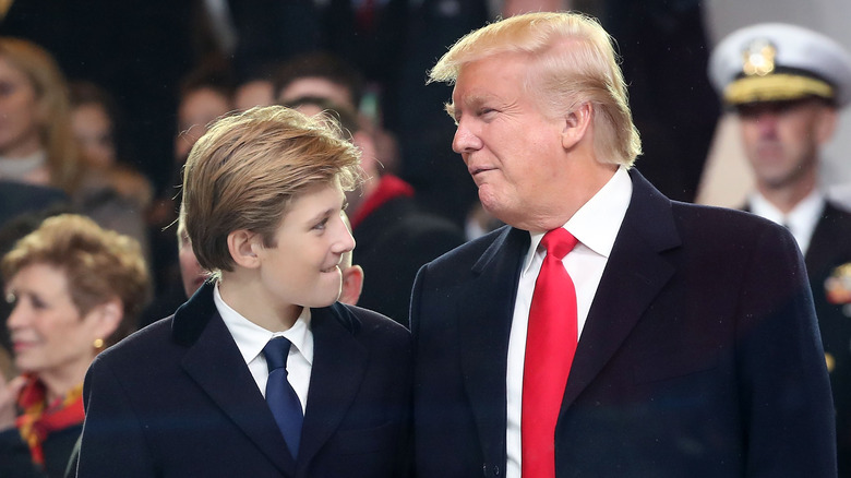 Barron Trump standing with Donald Trump